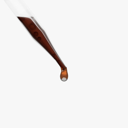 Brown dropper with a drop of liquid on a white background